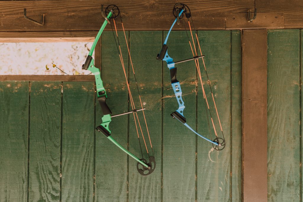two compound bows hanging